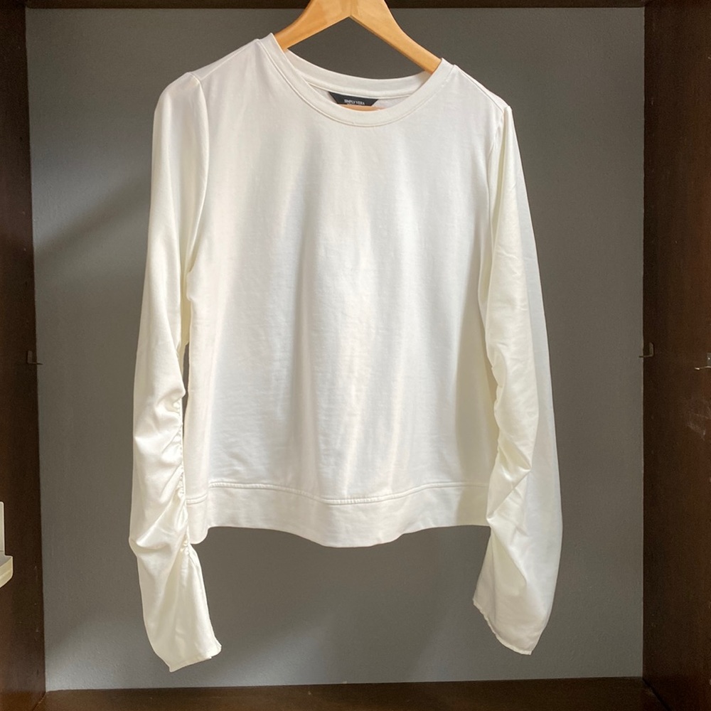 Silky, rouged detailed sleeves add a little oomph to this transitional top